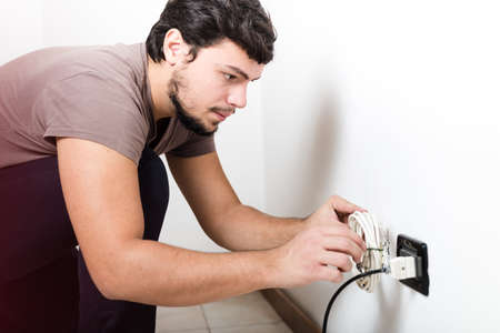 young man electrician bricolage working at home