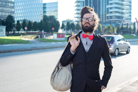 Stylish elegant dreadlocks businessman in business landscapeの写真素材