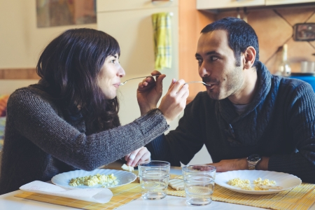 couple in love eatingin lunch at homeの写真素材