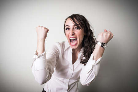 beautiful young businesswoman on gray backgroundの写真素材