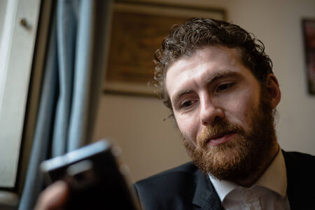 handsome bearded hipster elegant man on the cellphone