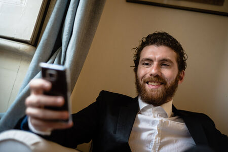 handsome bearded hipster elegant man on the cellphone