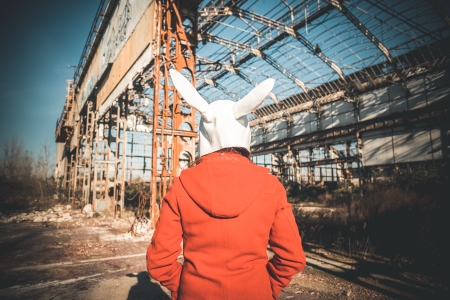 rabbit mask woman red coat winter desolate landscapeの写真素材