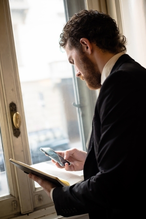handsome bearded hipster elegant man on the cellphoneの写真素材