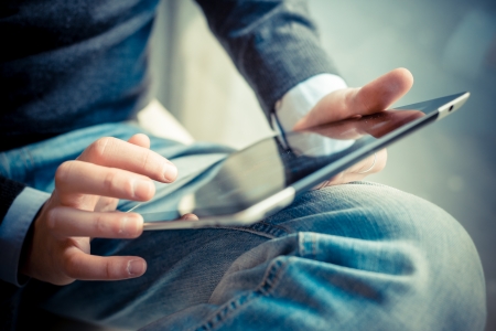 close up hands multitasking man using tablet, laptop and cellhpone connecting wifi close up hands multitasking man using tablet, laptop and cellhpone connecting wifi