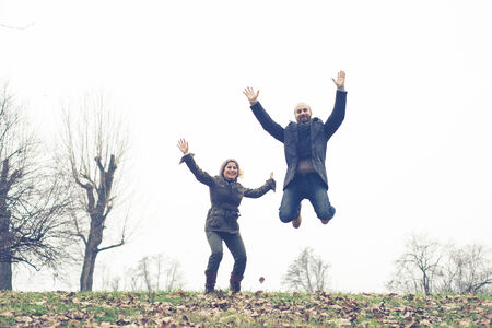 couple in love playing at the park winterの写真素材