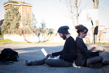 young couple in love lifestyle outdoor using tablet at the parkの写真素材