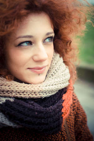 young beautiful red curly hair woman at the parkの写真素材