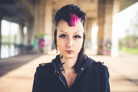 young beautiful punk dark girl in urban landscapeの写真素材