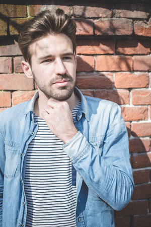 young handsome fashion model man outdoorsの写真素材
