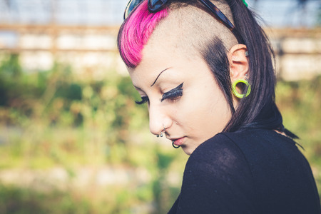 young beautiful punk dark girl in urban landscapeの写真素材