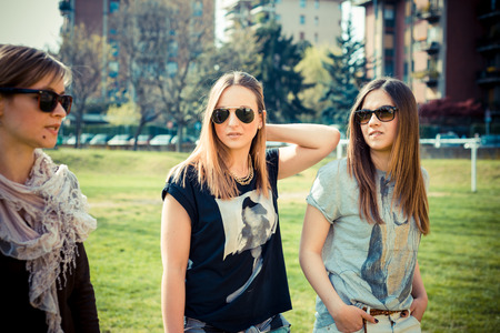 three beautiful friends authentic in urban contestの写真素材