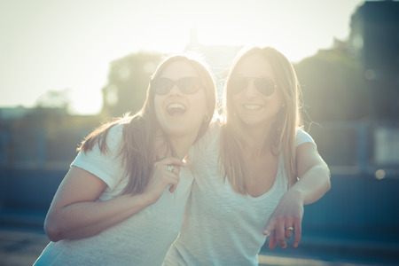 two beautiful young women in the cityの写真素材