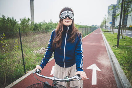 beautiful woman biker cycling in a desolate lurban landscape