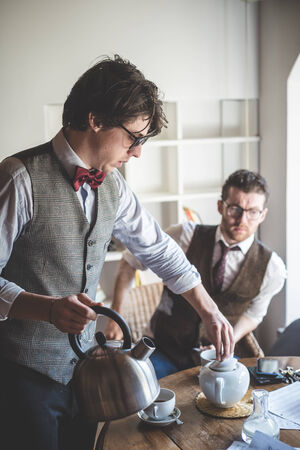 two young hipster stylish elegant men drinking teaの写真素材