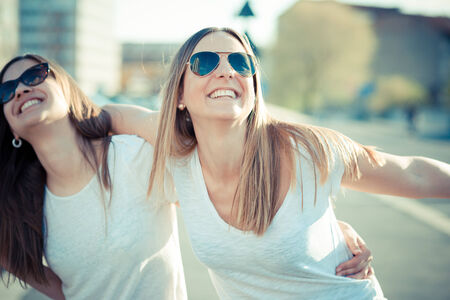 two beautiful young women having fun in the cityの写真素材