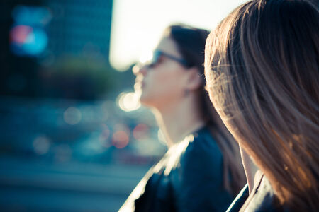 two blurred beautiful young women in the cityの写真素材