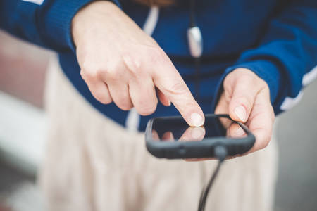 close up of woman hands using smart phone outdoor