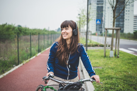 beautiful woman biker cycling in a desolate lurban landscapeの写真素材