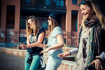 three beautiful friends authentic in urban contest dancingの写真素材