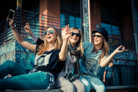 three beautiful friends authentic in urban contestの写真素材