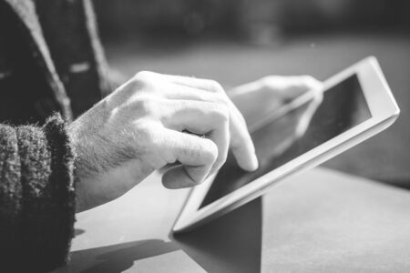 close up of hands man using tablet outdoorの写真素材