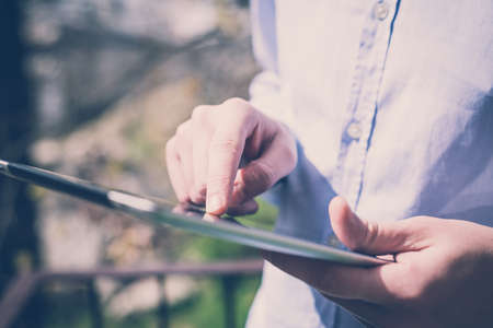 close up hands multitasking man using tabletの写真素材