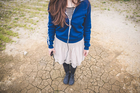 beautiful woman in a desolate lurban landscapeの写真素材