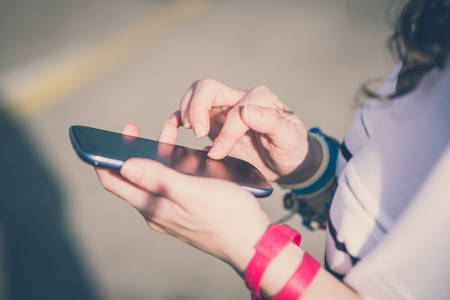 close up of hands woman using smart phone in the city