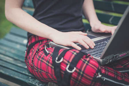 close up hands young lesbian stylish hair style woman using notebook in the cityの写真素材