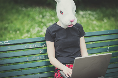 rabbit mask young lesbian stylish hair style woman using notebook in the cityの写真素材