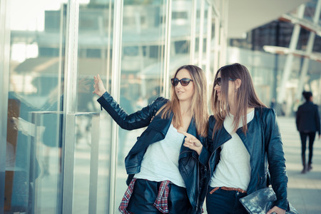 two beautiful young women shopping in the cityの写真素材
