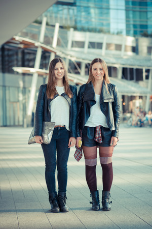 two beautiful young women in the cityの写真素材