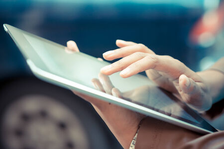 close up of african woman hands using tablet
