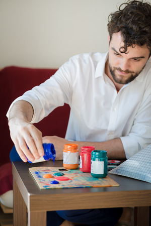 handsome hipster modern man painting at homeの写真素材