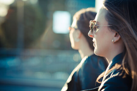 two beautiful young women in the cityの写真素材
