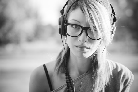 young beautiful model woman listening music in the cityの写真素材