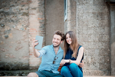 young beautiful couple lovers using tablet outdoorsの写真素材