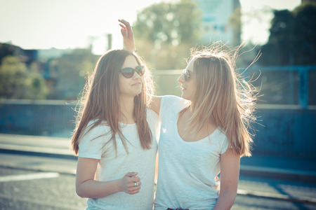 two beautiful young women having fun in the cityの写真素材