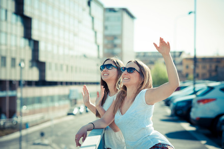 two beautiful young women in the cityの写真素材