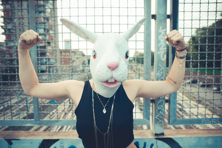 rabbit mask woman abusrd unreal in the cityの写真素材