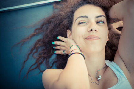 young beautiful long curly hair hipster woman in the city