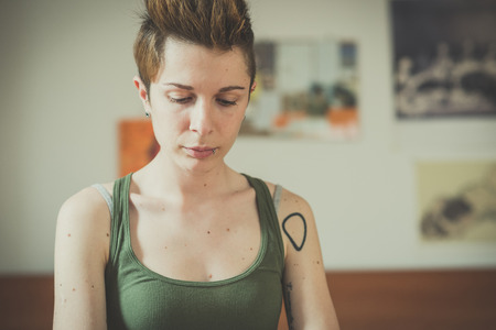 young lesbian stylish hair style woman using smart phone at homeの写真素材