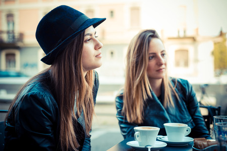 two beautiful friends authentic at the barの写真素材