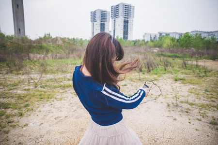 beautiful woman dancing in a desolate lurban landscapeの写真素材