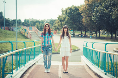 beautiful hipster young women sisters friends in the cityの写真素材