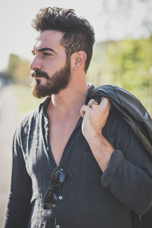 young handsome attractive bearded model man in urban contextの写真素材