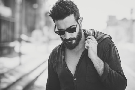 young handsome attractive bearded model man in urban contextの写真素材