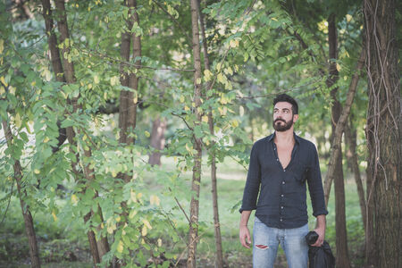 young handsome attractive bearded model man in the woodsの写真素材