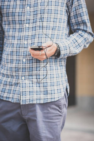 close up hand man using smartphone in the cityの写真素材